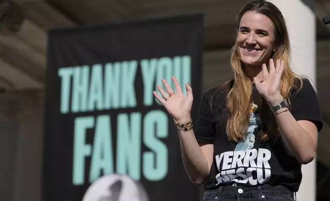 New York Liberty Sabrina Ionescu waves during a ceremony after a parade in honor of the Liberty's WNBA basketball championship at City Hall in New York, Thursday, Oct. 24, 2024. (AP Photo/Seth Wenig)