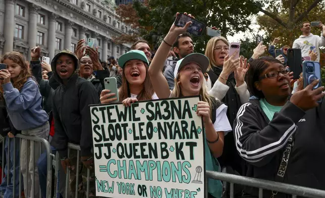 New York Liberty fans react while watching players parade down the Canyon of Heroes on Broadway celebrating the team's WNBA basketball championship, Thursday, Oct. 24, 2024, in New York. (AP Photo/Yuki Iwamura)