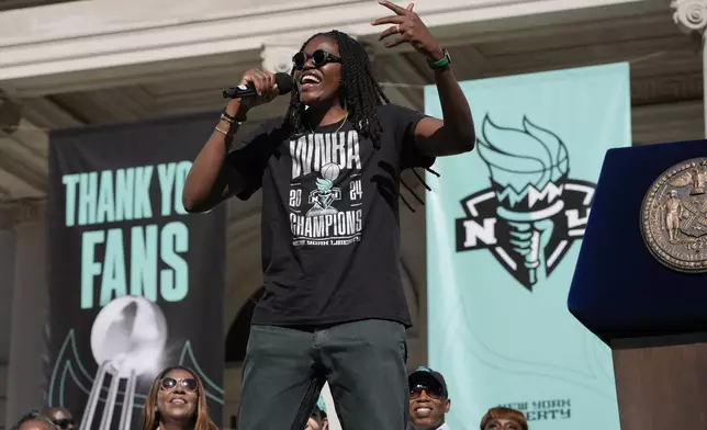 New York Liberty MVP Jonquel Jones celebrates during a ceremony after a parade in honor of the Liberty's WNBA basketball championship at City Hall in New York, Thursday, Oct. 24, 2024. (AP Photo/Seth Wenig)