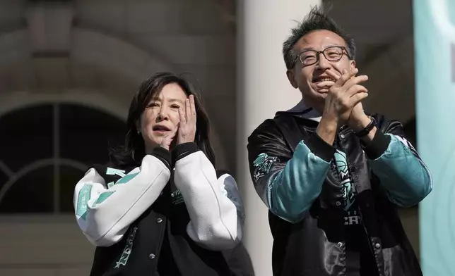 New York Liberty owners Clara Wu Tsai and Joe Tsai applaud during a ceremony after a parade in honor of the Liberty's WNBA basketball championship at City Hall in New York, Thursday, Oct. 24, 2024. (AP Photo/Seth Wenig)