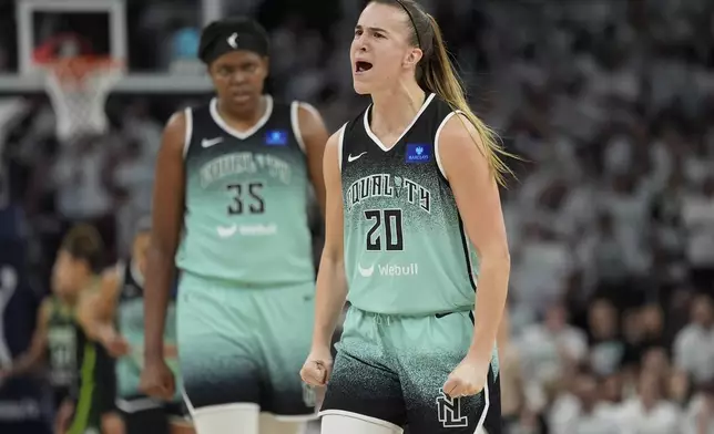 New York Liberty guard Sabrina Ionescu (20) reacts after making a three-point basket during the second half against the Minnesota Lynx in Game 3 of a WNBA basketball final playoff series, Wednesday, Oct. 16, 2024, in Minneapolis. (AP Photo/Abbie Parr)