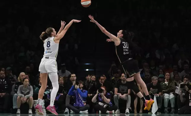 Minnesota Lynx forward Alanna Smith (8) puts up a shot against New York Liberty forward Breanna Stewart (30) during the first quarter of Game 5 of the WNBA basketball final series, Sunday, Oct. 20, 2024, in New York. (AP Photo/Pamela Smith)