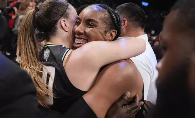 New York Liberty forward Kayla Thornton (5) hugs guard Sabrina Ionescu (20) after the Liberty defeated the Minnesota Lynx in Game 5 of the WNBA basketball final series to win the championship, Sunday, Oct. 20, 2024, in New York. (AP Photo/Pamela Smith)