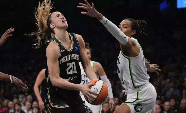 New York Liberty guard Sabrina Ionescu (20) goes up for a shot against Minnesota Lynx forward Napheesa Collier (24) during the first quarter of Game 5 of the WNBA basketball final series, Sunday, Oct. 20, 2024, in New York. (AP Photo/Pamela Smith)