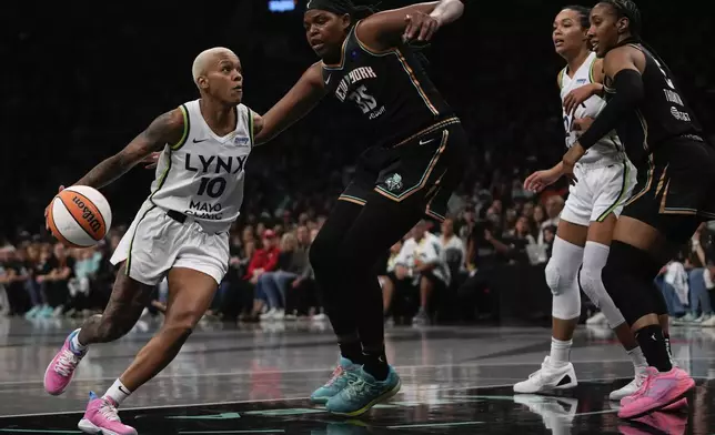 Minnesota Lynx guard Courtney Williams (10) drives against New York Liberty forward Jonquel Jones (35) during the third quarter of Game 5 of the WNBA basketball final series, Sunday, Oct. 20, 2024, in New York. (AP Photo/Pamela Smith)