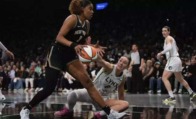 New York Liberty forward Nyara Sabally (8) grabs control of a rebound against Minnesota Lynx forward Alanna Smith (8) during the first quarter of Game 5 of the WNBA basketball final series, Sunday, Oct. 20, 2024, in New York. (AP Photo/Pamela Smith)