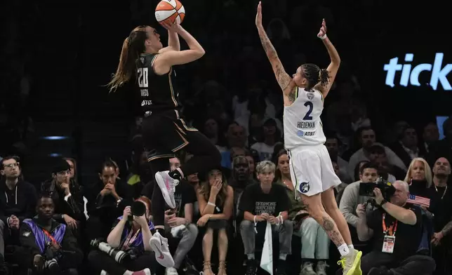 New York Liberty guard Sabrina Ionescu (20) puts up a shot against Minnesota Lynx guard Natisha Hiedeman (2) during the fourth quarter of Game 5 of the WNBA basketball final series, Sunday, Oct. 20, 2024, in New York. (AP Photo/Pamela Smith)