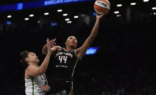 New York Liberty forward Betnijah Laney-Hamilton (44) puts up a shot against Minnesota Lynx guard Kayla McBride (21) during the first quarter of Game 5 of the WNBA basketball final series, Sunday, Oct. 20, 2024, in New York. (AP Photo/Pamela Smith)