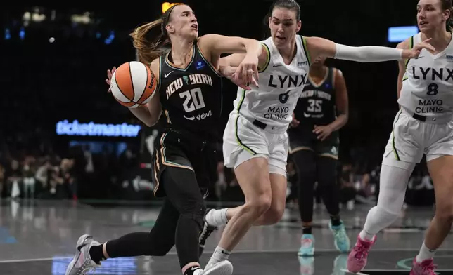 New York Liberty guard Sabrina Ionescu (20) drives against Minnesota Lynx forward Bridget Carleton (6) during the second quarter of Game 5 of the WNBA basketball final series, Sunday, Oct. 20, 2024, in New York. (AP Photo/Pamela Smith)