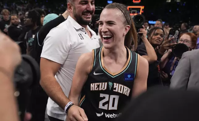 New York Liberty guard Sabrina Ionescu (20) celebrates after the Liberty defeated the Minnesota Lynx in Game 5 of the WNBA basketball final series to win the WNBA championship, Sunday, Oct. 20, 2024, in New York. (AP Photo/Pamela Smith)