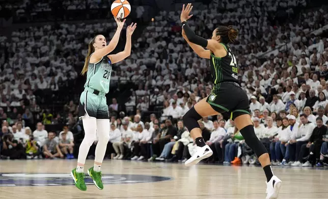 New York Liberty guard Sabrina Ionescu (20) shoots over Minnesota Lynx forward Napheesa Collier, right, during the first half in Game 3 of a WNBA basketball final playoff series, Wednesday, Oct. 16, 2024, in Minneapolis. (AP Photo/Abbie Parr)