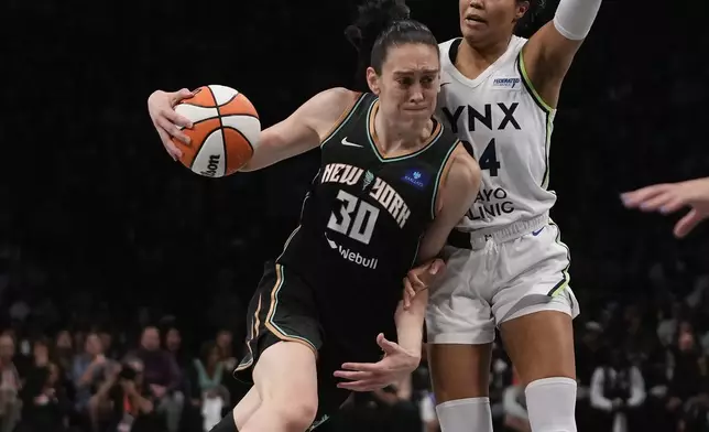 New York Liberty forward Breanna Stewart (30) drives against Minnesota Lynx forward Napheesa Collier (24) during the second quarter of Game 5 of the WNBA basketball final series, Sunday, Oct. 20, 2024, in New York. (AP Photo/Pamela Smith)