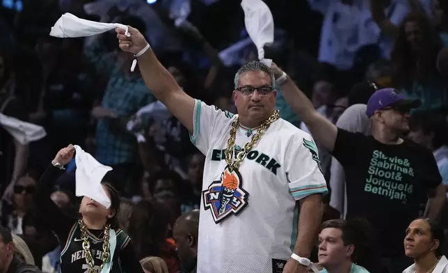 New York Liberty fans wave rally towels during a break in play against the Minnesota Lynx during the fourth quarter of Game 5 of the WNBA basketball final series, Sunday, Oct. 20, 2024, in New York. (AP Photo/Pamela Smith)