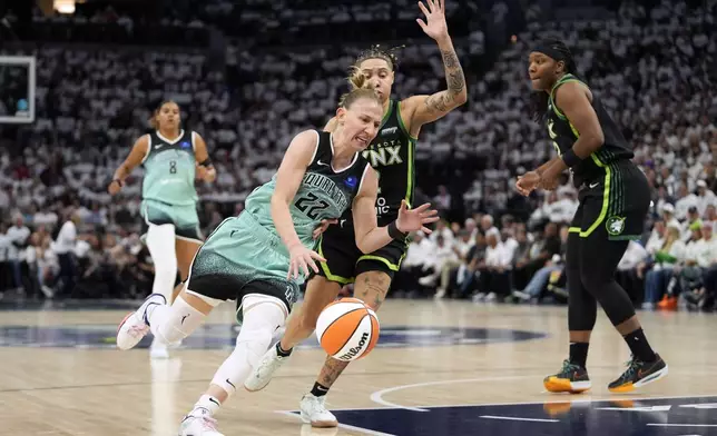 New York Liberty guard Courtney Vandersloot (22) drives to the basket past Minnesota Lynx guard Natisha Hiedeman during the first half in Game 3 of a WNBA basketball final playoff series, Wednesday, Oct. 16, 2024, in Minneapolis. (AP Photo/Abbie Parr)