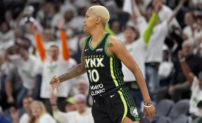 Minnesota Lynx guard Courtney Williams reacts after making a 3-point basket during the second half against the New York Liberty in Game 3 of a WNBA basketball final playoff series, Wednesday, Oct. 16, 2024, in Minneapolis. (AP Photo/Abbie Parr)