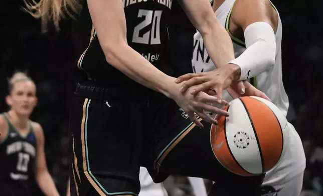 New York Liberty guard Sabrina Ionescu (20) is fouled by Minnesota Lynx forward Napheesa Collier (24) during the first quarter of Game 5 of the WNBA basketball final series, Sunday, Oct. 20, 2024, in New York. (AP Photo/Pamela Smith)