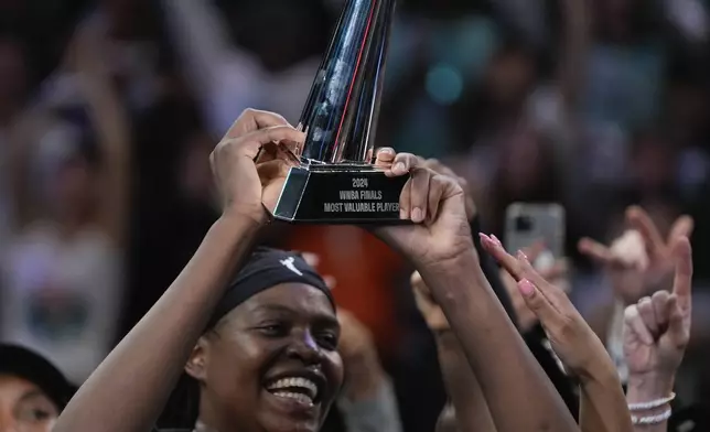 New York Liberty forward Jonquel Jones reacts after being given the MVP Award after winning the championship against the Minnesota Lynx in Game 5 of the WNBA basketball final series, Sunday, Oct. 20, 2024, in New York. (AP Photo/Pamela Smith)