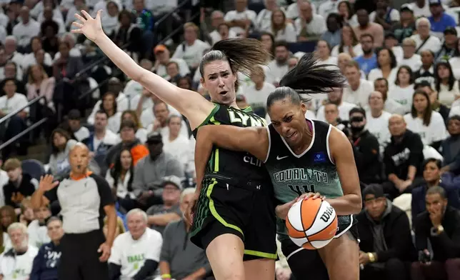 Minnesota Lynx forward Bridget Carleton, left, is fouled by New York Liberty forward Betnijah Laney-Hamilton (44) during the first half in Game 3 of a WNBA basketball final playoff series, Wednesday, Oct. 16, 2024, in Minneapolis. (AP Photo/Abbie Parr)