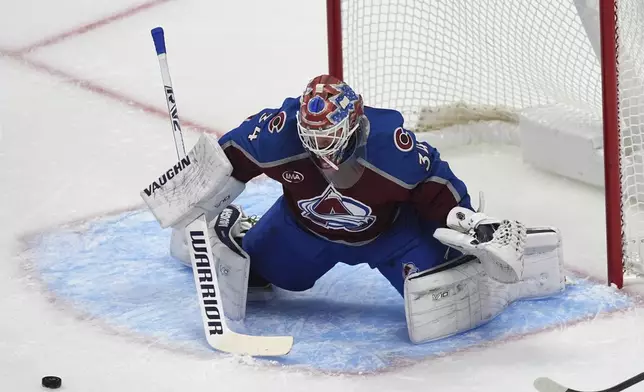 Colorado Avalanche goaltender Kaapo Kahkonen (34) stops a shot in the first period of an NHL hockey game against the Tampa Bay Lightning Wednesday, Oct. 30, 2024, in Denver. (AP Photo/David Zalubowski)