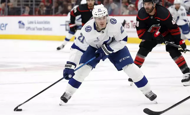 Tampa Bay Lightning's Brayden Point (21) carries the puck downice against the Carolina Hurricanes during the first period of an NHL hockey game in Raleigh, N.C., Friday, Oct. 11, 2024. (AP Photo/Karl B DeBlaker)