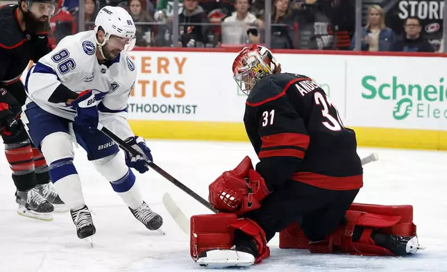 Tampa Bay Lightning's Nikita Kucherov (86) has his shot stopped by Carolina Hurricanes goaltender Frederik Andersen (31) during the first period of an NHL hockey game in Raleigh, N.C., Friday, Oct. 11, 2024. (AP Photo/Karl B DeBlaker)