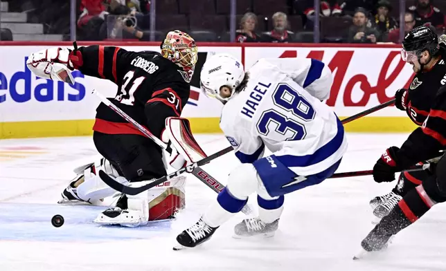 Ottawa Senators goaltender Anton Forsberg (31) makes a save on Tampa Bay Lightning left wing Brandon Hagel (38) during first period NHL hockey action in Ottawa, on Saturday, Oct. 19, 2024. (Justin Tang/The Canadian Press via AP)