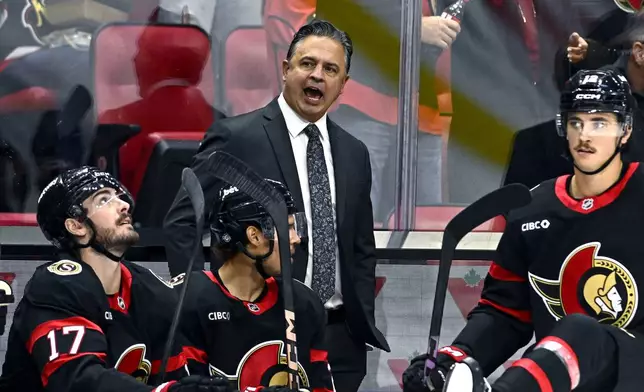 Ottawa Senators head coach Travis Green directs his players from the bench during first period NHL hockey action between the Senators and the Tampa Bay Lightning in Ottawa, on Saturday, Oct. 19, 2024. (Justin Tang/The Canadian Press via AP)