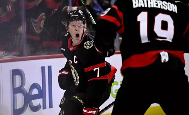 Ottawa Senators left wing Brady Tkachuk celebrates his goal against the Tampa Bay Lightning with teammate Drake Batherson (19) during the second period of an NHL hockey game in Ottawa, Saturday, Oct. 19, 2024. (Justin Tang/The Canadian Press via AP)