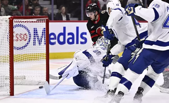 Ottawa Senators right wing Drake Batherson (19) watches his shot go in the net behind Tampa Bay Lightning goaltender Andrei Vasilevskiy (88) during the second period of an NHL hockey game in Ottawa, Saturday, Oct. 19, 2024. (Justin Tang/The Canadian Press via AP)