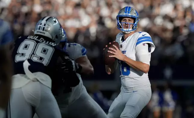 Detroit Lions quarterback Jared Goff drops back to pass under pressure from Dallas Cowboys defensive end Chauncey Golston (99) in the second half of an NFL football game in Arlington, Texas, Sunday, Oct. 13, 2024. (AP Photo/LM Otero)