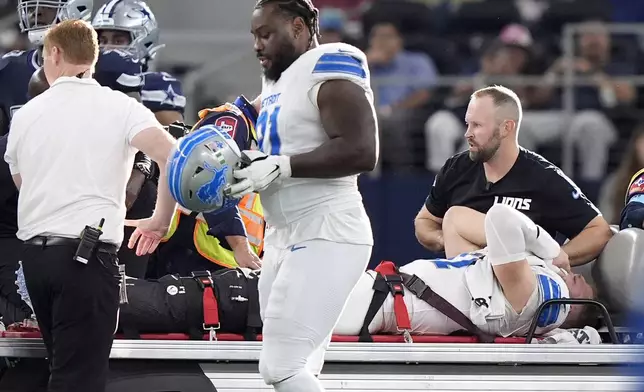 Detroit Lions defensive end Aidan Hutchinson is carted off the field after suffering an unknown injur in the second half of an NFL football game against the Dallas Cowboys in Arlington, Texas, Sunday, Oct. 13, 2024. (AP Photo/LM Otero)