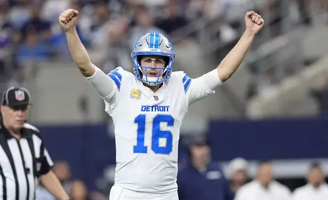 Detroit Lions quarterback Jared Goff (16) celebrates after David Montgomery scored a touchdown against the Dallas Cowboys in the first half of an NFL football game in Arlington, Texas, Sunday, Oct. 13, 2024. (AP Photo/LM Otero)