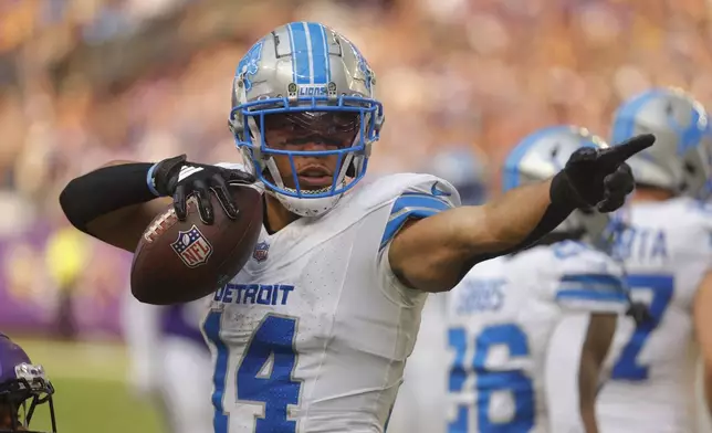 Detroit Lions wide receiver Amon-Ra St. Brown (14) signals a first down against the Minnesota Vikings during the second half of an NFL football game Sunday, Oct. 20, 2024, in Minneapolis. (AP Photo/Bruce Kluckhohn)