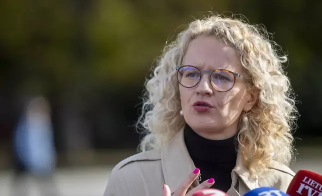 Freedom Party leader Ausrine Armonaite speaks to the members of press at a polling station during the advance parliamentary elections in Vilnius, Lithuania, Wednesday, Oct. 9, 2024. (AP Photo/Mindaugas Kulbis)