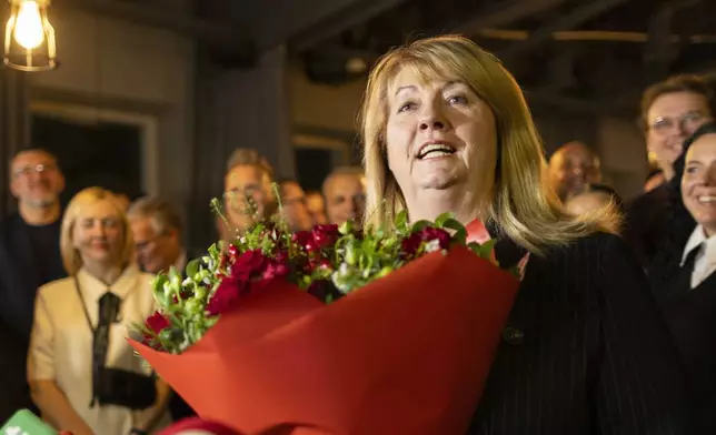 Leader of the Social Democratic Party Vilija Blinkeviciute speaks to the media while waiting for the results of the second round of Lithuania's parliamentary election, in an office in Vilnius, Lithuania, Sunday, Oct. 27, 2024. (AP Photo/Mindaugas Kulbis)