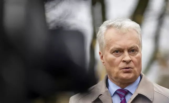 Lithuania's President Gitanas Nauseda speaks to press at a polling station during a second round of voting in parliamentary election, in Vilnius, Lithuania, Sunday, Oct. 27, 2024. (AP Photo/Mindaugas Kulbis)