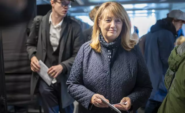 Leader of the Social Democratic Party Vilija Blinkeviciute arrives at a polling station during the advance parliamentary elections in Vilnius, Lithuania, Wednesday, Oct. 9, 2024. (AP Photo/Mindaugas Kulbis)