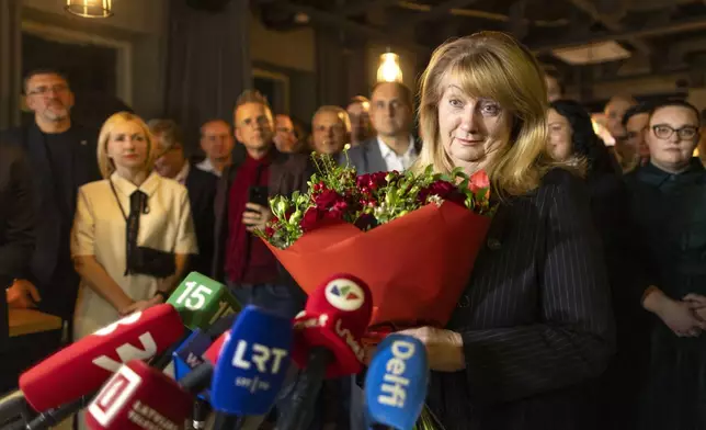 Leader of the Social Democratic Party Vilija Blinkeviciute speaks to the media while waiting for the results of the second round of Lithuania's parliamentary election, in an office in Vilnius, Lithuania, Sunday, Oct. 27, 2024. (AP Photo/Mindaugas Kulbis)