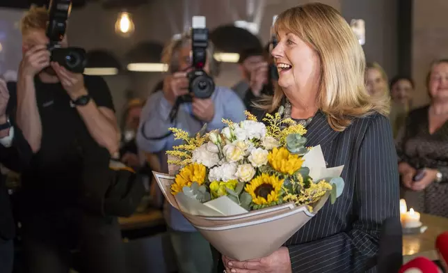 Leader of the Social Democratic Party Vilija Blinkeviciute smiles as she waits for the results of the first round of Lithuania's parliamentary election, in Vilnius, Lithuania, Sunday, Oct. 13, 2024. (AP Photo/Mindaugas Kulbis)