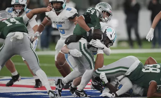 De La Salle running back Duece Jones-Drew carries the ball during a football game between the NFL Academy team and De La Salle high school, Tuesday, Oct. 8, 2024, in London. (AP Photo/Kin Cheung)