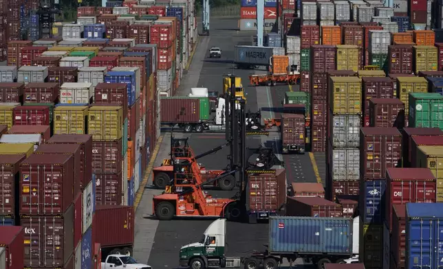 FILE - Containers are moved at the Port of New York and New Jersey in Elizabeth, N.J., on June 30, 2021. (AP Photo/Seth Wenig, File)