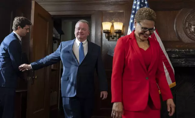 Los Angeles Mayor Karen Bass, right, and newly appointed police chief Jim McDonnell, center, arrive for a news conference in Los Angeles, Friday, Oct. 4, 2024. (AP Photo/Jae C. Hong)