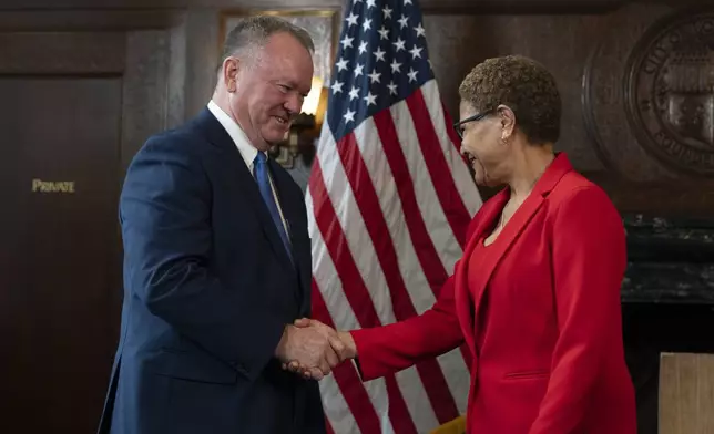 Los Angeles Mayor Karen Bass, right, and newly appointed police chief Jim McDonnell shake hands during a news conference in Los Angeles, Friday, Oct. 4, 2024. (AP Photo/Jae C. Hong)