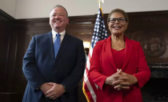 Los Angeles Mayor Karen Bass, right, and newly appointed police chief Jim McDonnell share a light moment during a news conference in Los Angeles, Friday, Oct. 4, 2024. (AP Photo/Jae C. Hong)