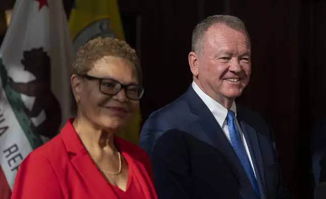 Los Angeles Mayor Karen Bass, left, and newly appointed police chief Jim McDonnell listen to questions from the media during a news conference in Los Angeles, Friday, Oct. 4, 2024. (AP Photo/Jae C. Hong)