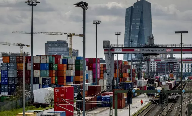 FILE - Containers are piled up at a cargo terminal of Deutsche Bahn in Frankfurt, Germany, Wednesday, April 26, 2023. In the background is the European Central Bank building. (AP Photo/Michael Probst, File)