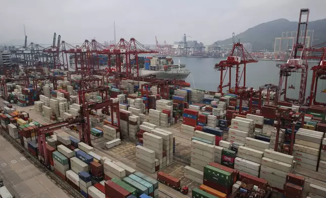 FILE - Gantry cranes load cargo onto container ships at a port of Kwai Tsing Container Terminals in Hong Kong, Friday, May 24, 2019. (AP Photo/Kin Cheung, File)