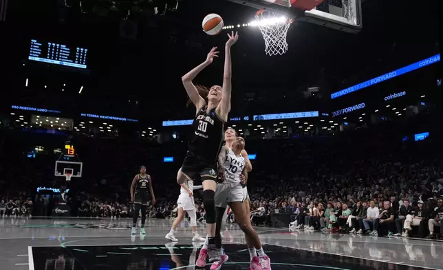 New York Liberty's Breanna Stewart (30) shoots during the first half in Game 2 of a WNBA basketball final playoff series against the Minnesota Lynx, Sunday, Oct. 13, 2024, in New York. (AP Photo/Pamela Smith)