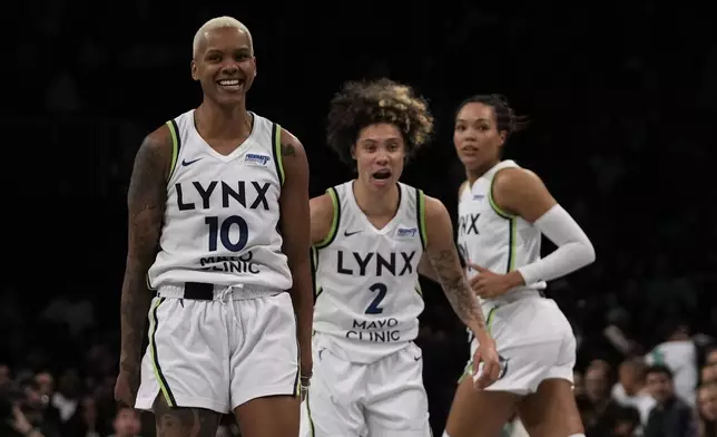 Minnesota Lynx's Courtney Williams, left, reacts after scoring during the second half in Game 2 of a WNBA basketball final playoff series against the New York Liberty, Sunday, Oct. 13, 2024, in New York. (AP Photo/Pamela Smith)