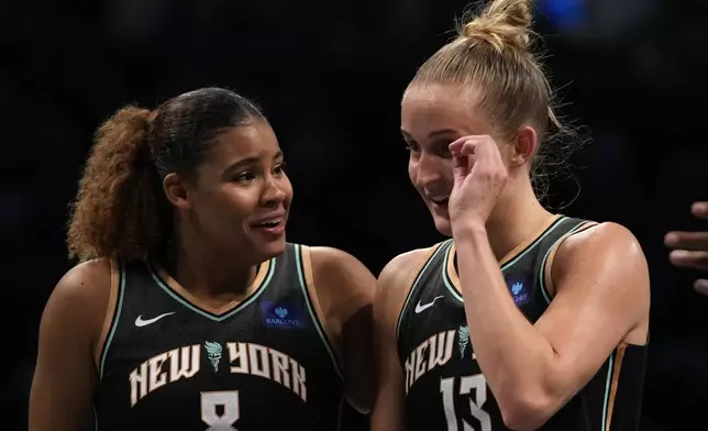 New York Liberty's Nyara Sabally, left, and Leonie Fiebich, right, react after defeating the Minnesota Lynx in Game 2 of a WNBA basketball final playoff series, Sunday, Oct. 13, 2024, in New York. (AP Photo/Pamela Smith)